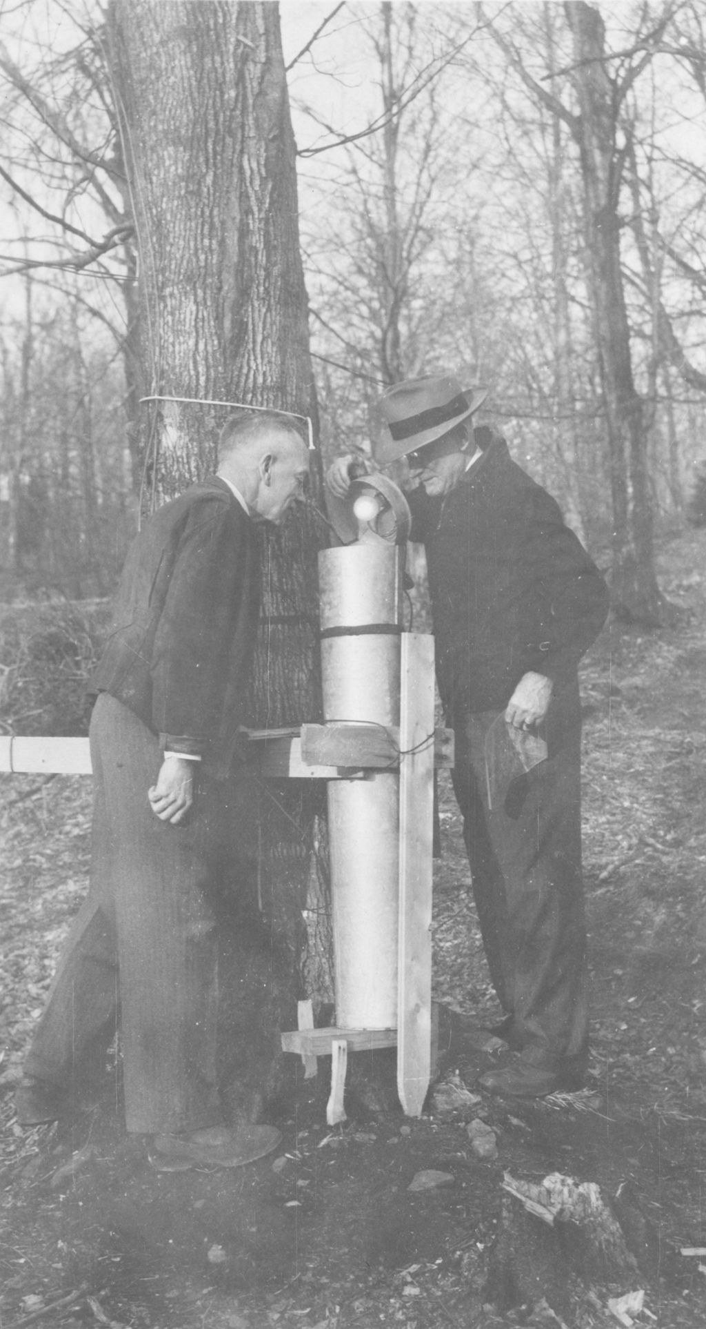 Miniature of E. Root and Dean Carrigan checking collection tank