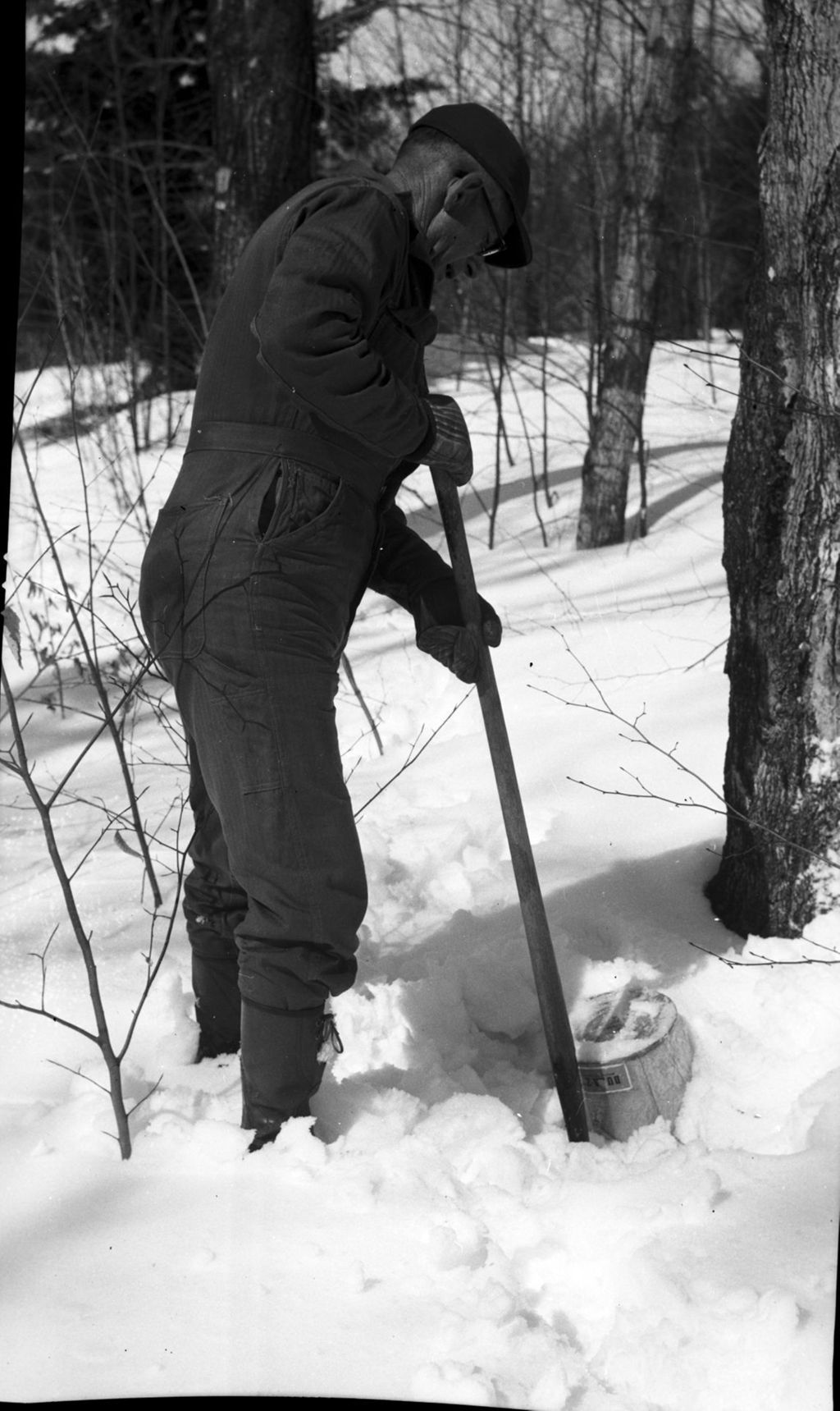 Miniature of Worker digging a collection bucket out of the snow