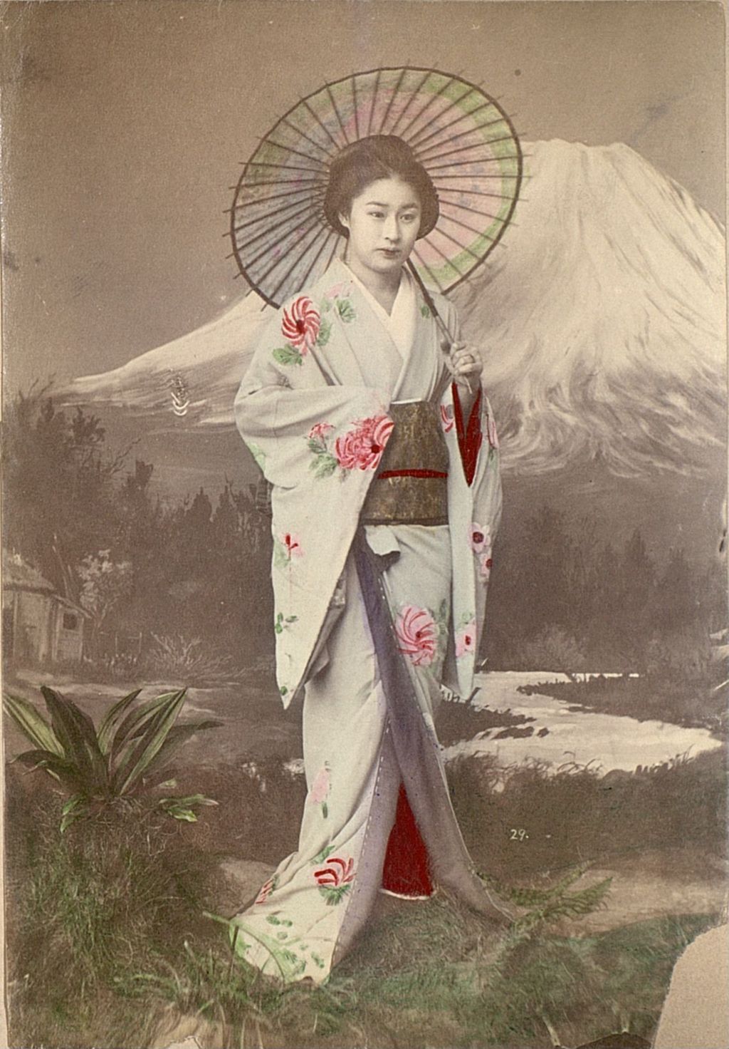 Miniature of Woman with umbrella posing in front of a mural of Mt Fuji