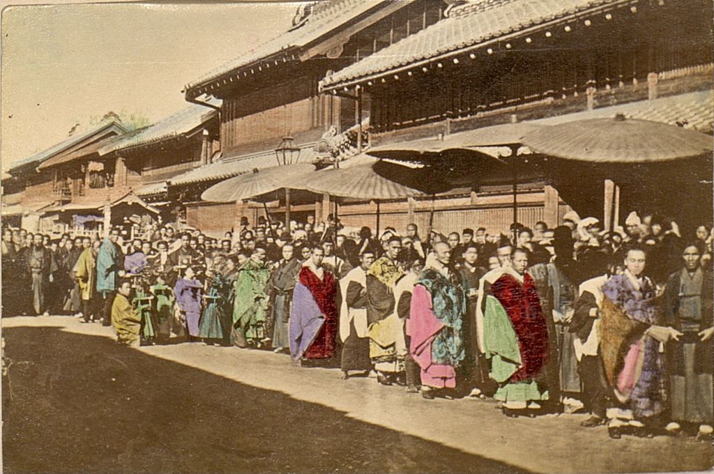 Miniature of People lined up to view a parade or procession