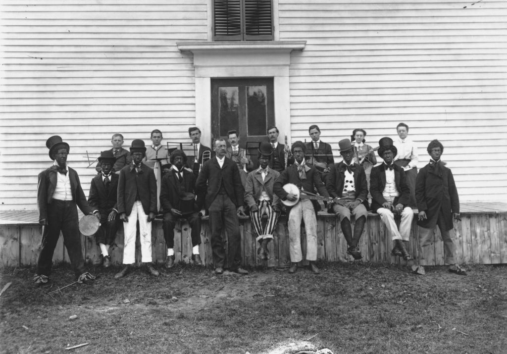 Miniature of Portrait of actors in blackface and band members in front of a clabbered building in East Dover, Vt.