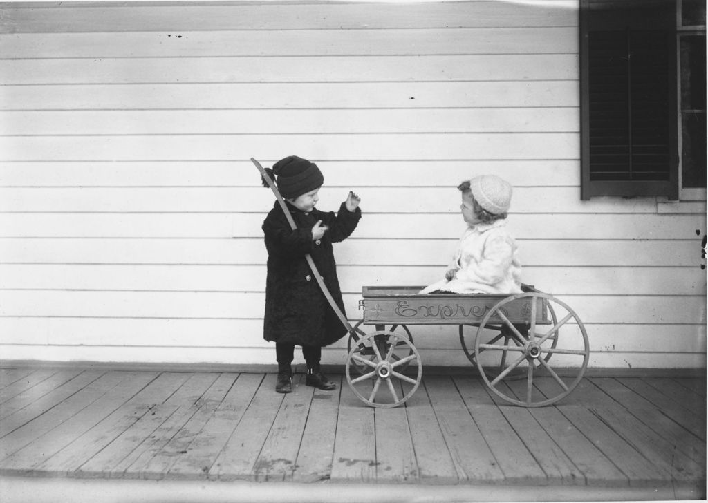 Miniature of Children with a wagon on a house porch