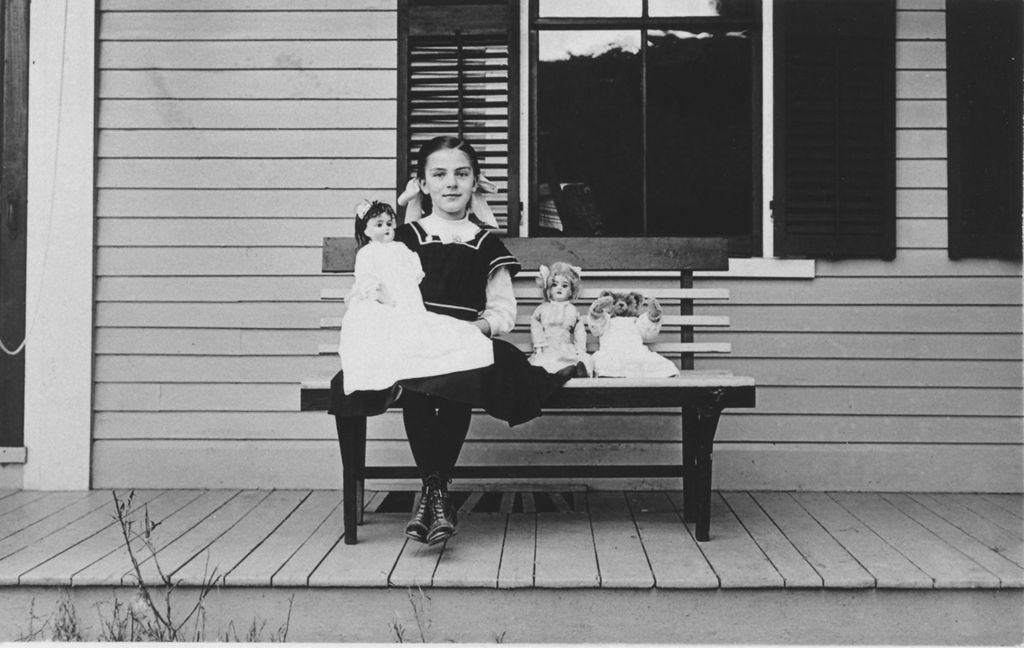 Miniature of Ruth Wheeler sitting on a porch with dolls, Willimasville, Vt.